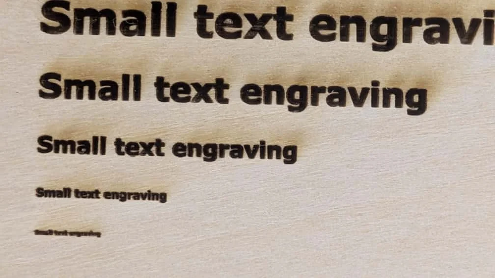 Engraving result on wooden board at 1200 DPI resolution.