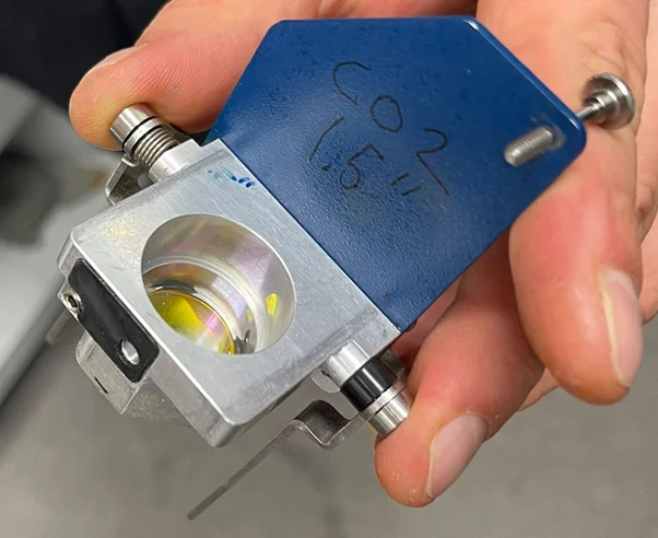 Photo of the laser cutter focusing lens component.